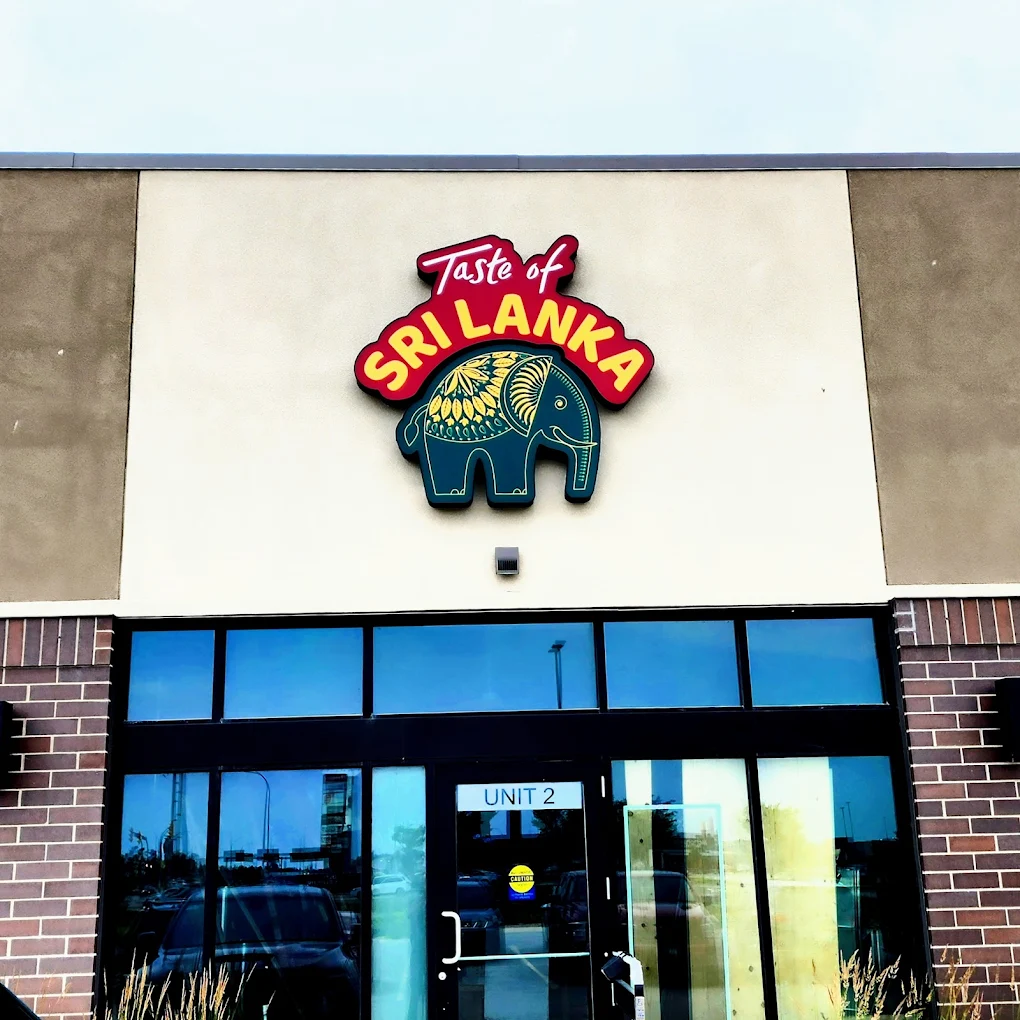 Taste of Sri Lanka storefront at 635 Sterling Lyon Pkwy, Unit 2, Winnipeg — illuminated sign with the teal Sri Lankan elephant above the entrance